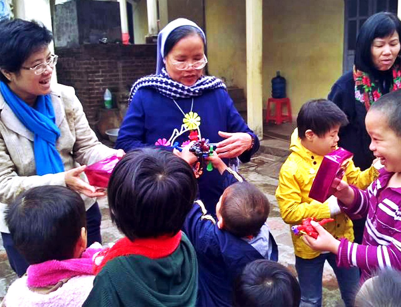 Happy orphans from Xuy Xa Orphanage receiving their Christmas gifts donated by DnM