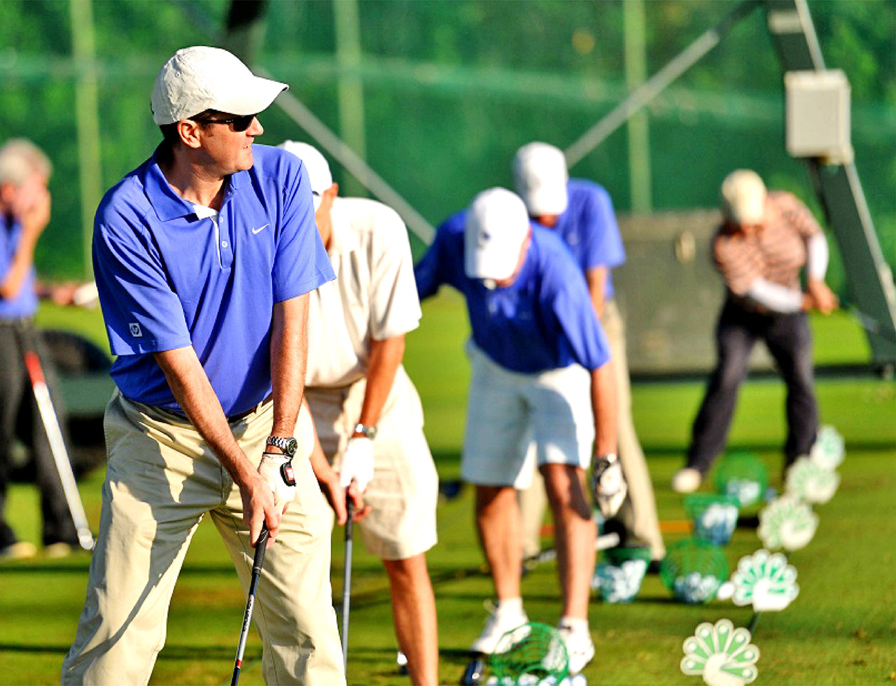Business associates playing golf during a corporate teambuilding event