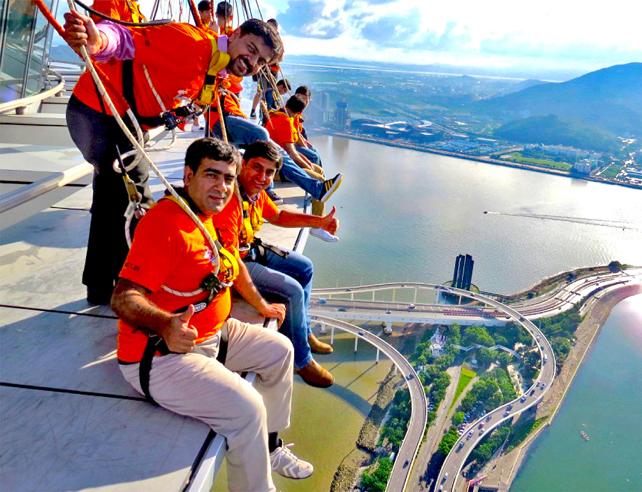 A group of business delegates enjoying a fun, thrilling skywalk experience at Macau tower
